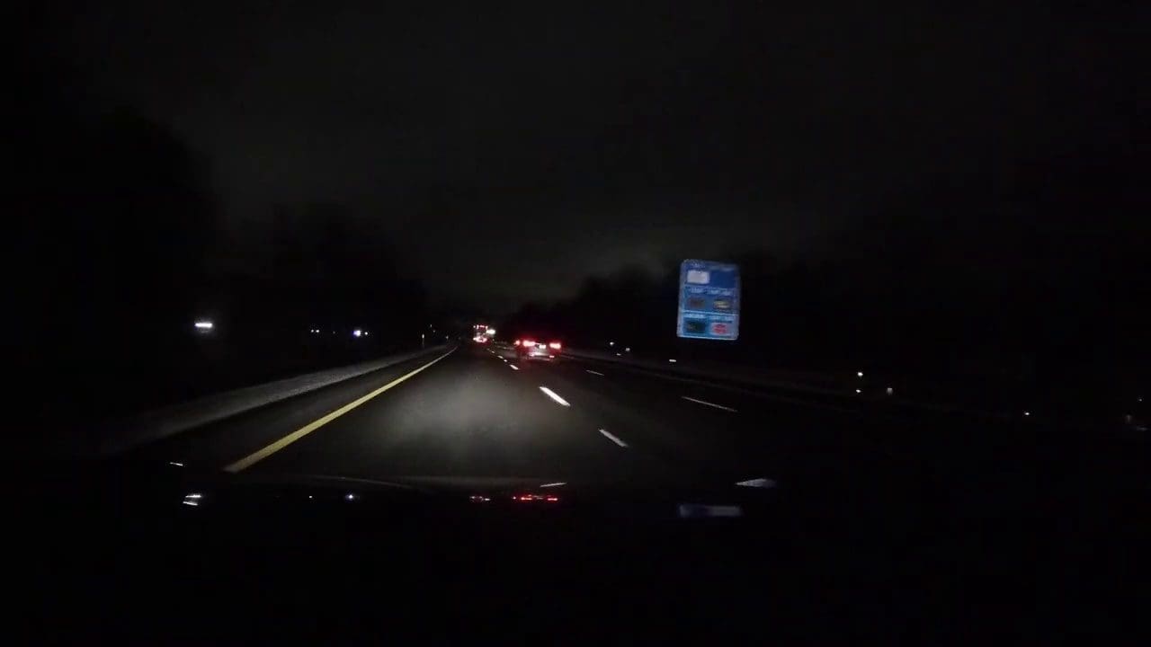 Highway sign at night from a poor quality video